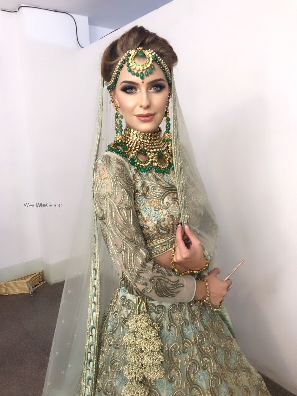 Photo of Stunning light grey and blue bridal lehenga with green beads