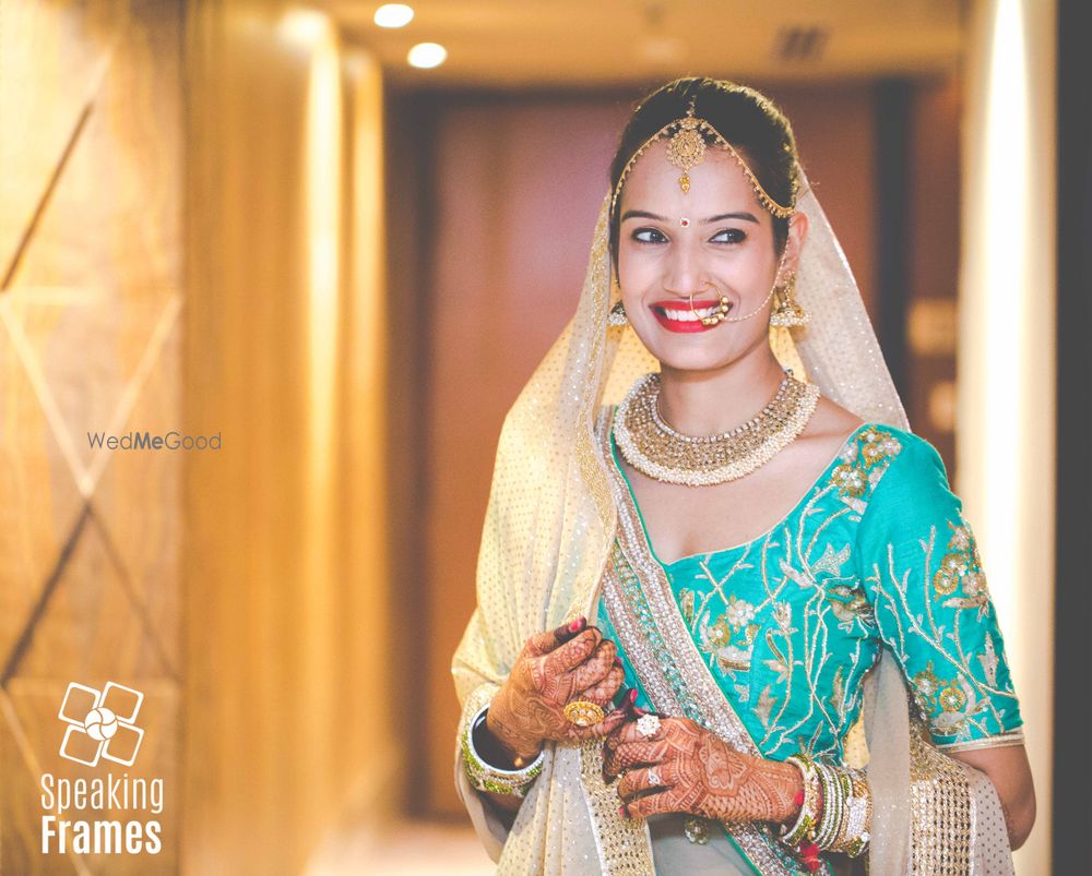 Photo of Bride in Aqua Lehenga with gold motifs