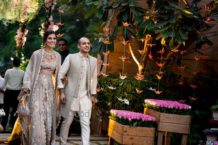 Photo of Matching bride and groom on mehendi in grey outfits