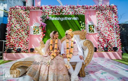 Photo of Wedding day stage backdrop with hashtag