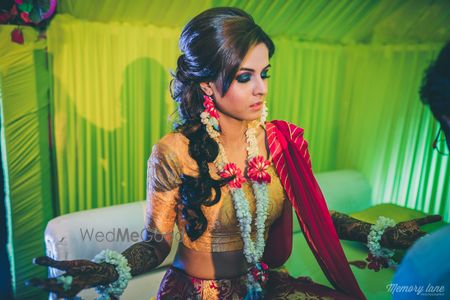 Photo of Mehendi braided hairstyle with smokey eyes