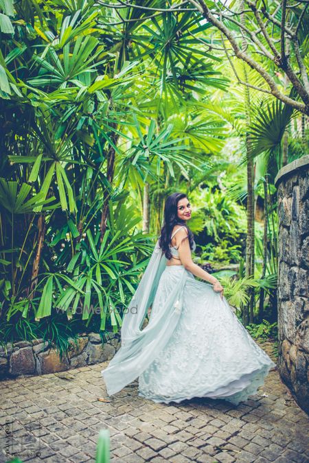 Photo of Bride twirling in light blue lehenga on engagement