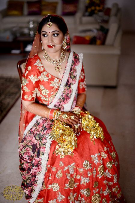 Photo of Red and gold bridal lehenga with floral print dupatta