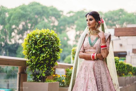 Photo of Light pink lehenga contrasting jewellery