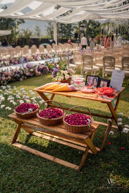 Photo of Lovely memory table with petal baskets at an outdoor wedding