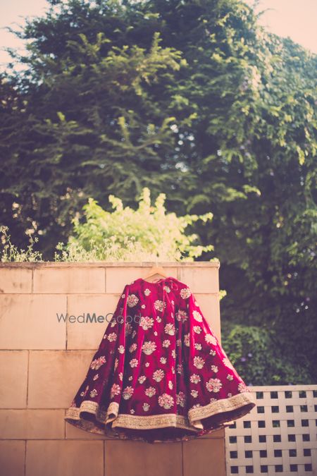 Photo of Maroon velvet bridal lehenga with gold embroidery