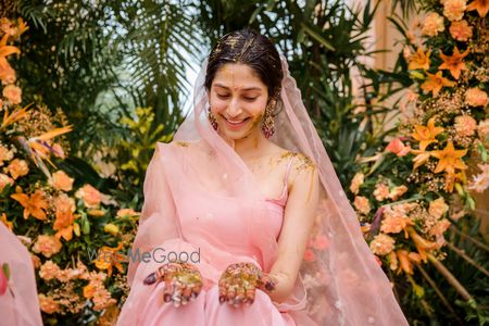 Photo of Bride wearing a pastel pink sharara set on her Haldi.