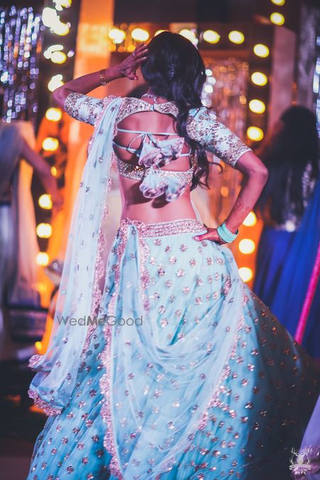 Photo of Girly engagement lehenga with unique blouse back style