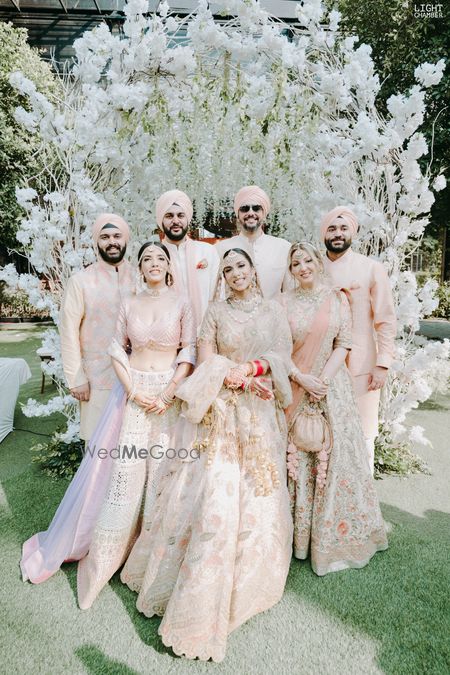 Photo of sikh bridal family portrait in coordinated outfits