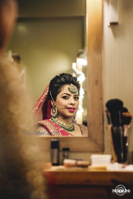 Photo of bride looking in mirror