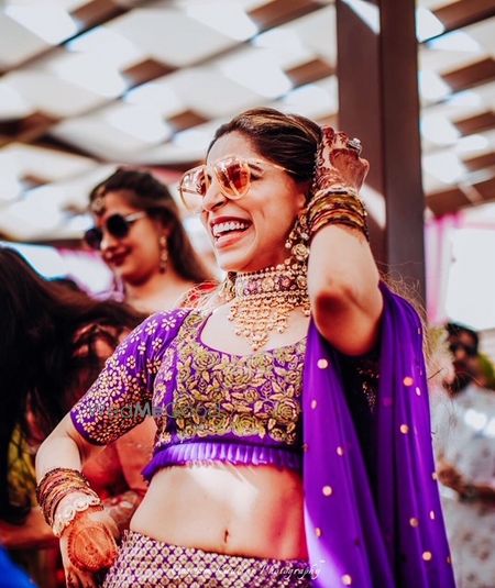 Photo of Mehendi jewellery with purple lehenga happy bride