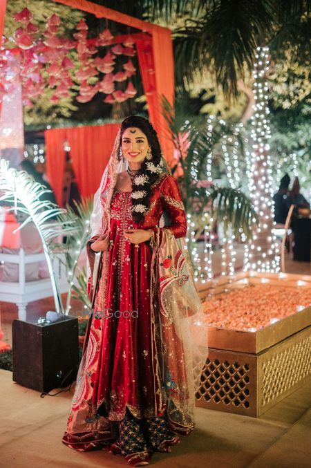 Photo of Bride dressed in a unique mehndi outfit with a braided hairdo.