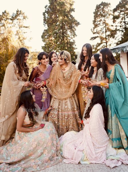 Photo of Bride and bridesmaids pose for wedding portrait