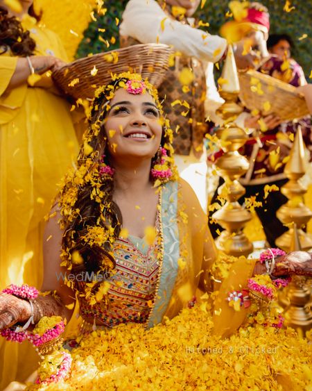 Photo of flower shower on bride on haldi