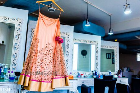 Photo of warm peach lehenga with hot pink carnation latkan