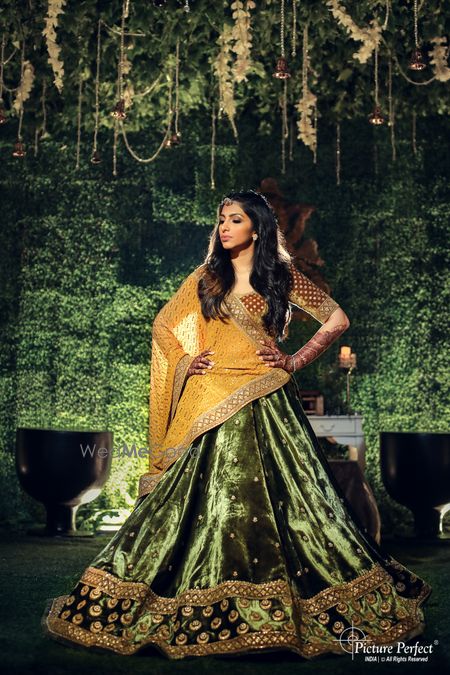 Photo of lehenga for the sangeet in green velvet and yellow dupatta