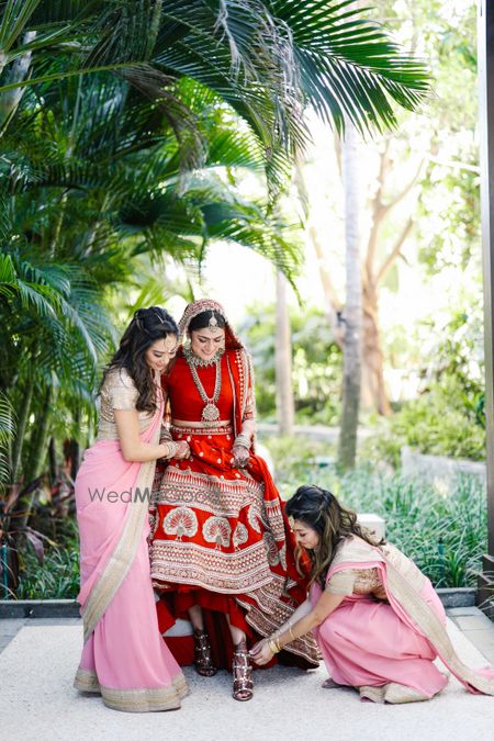 Photo of Bridesmaids helping the bride get ready