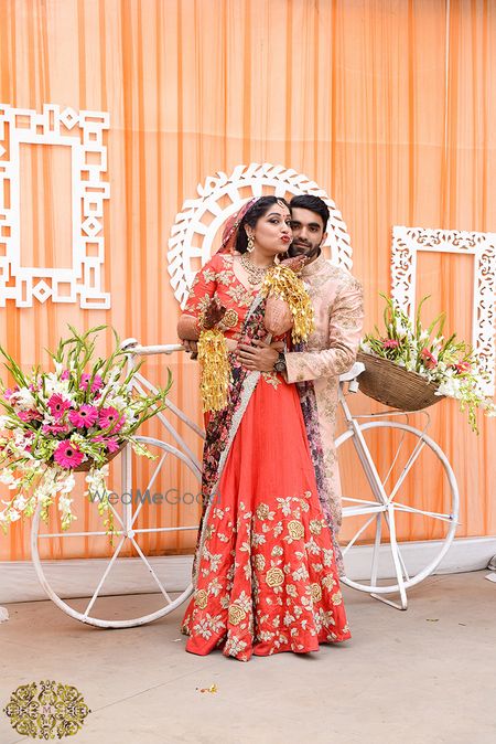 Photo of Red and gold bridal lehenga with floral print dupatta