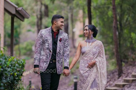 Photo of couple portrait in coordinated lavender outfits for welcome dinner