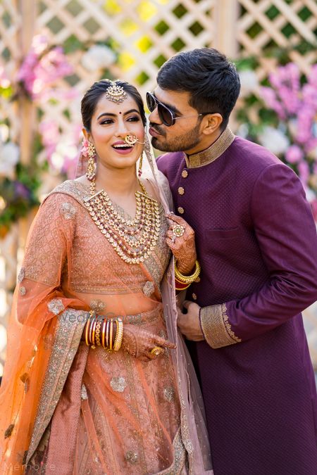 Photo of bridal portrait with her brother kissing her