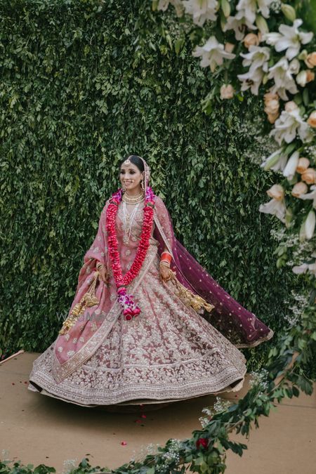 Photo of A bride in a pink lehenga for the wedding