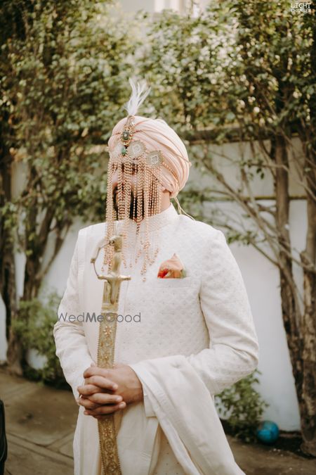 Photo of sikh groom wearing sherwani with shera