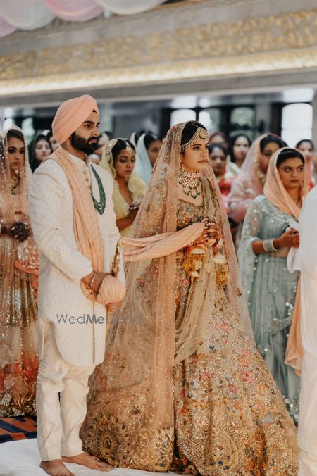 Photo of Bride in a dull gold lehenga