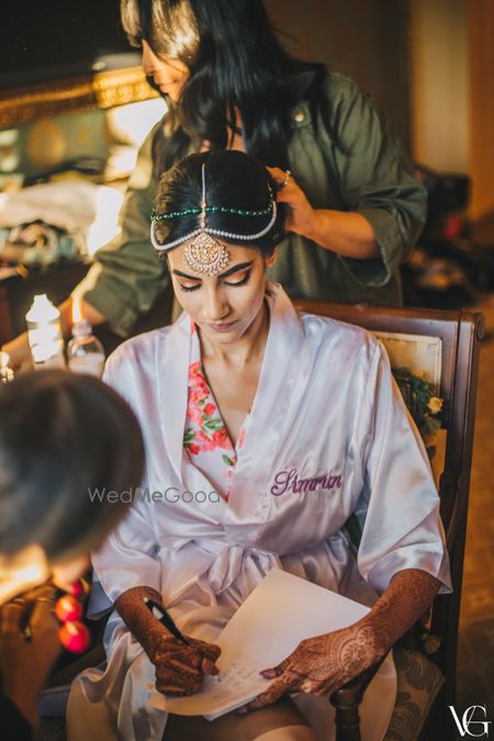 Photo of Bride wearing a customised bridal robe with her name on it