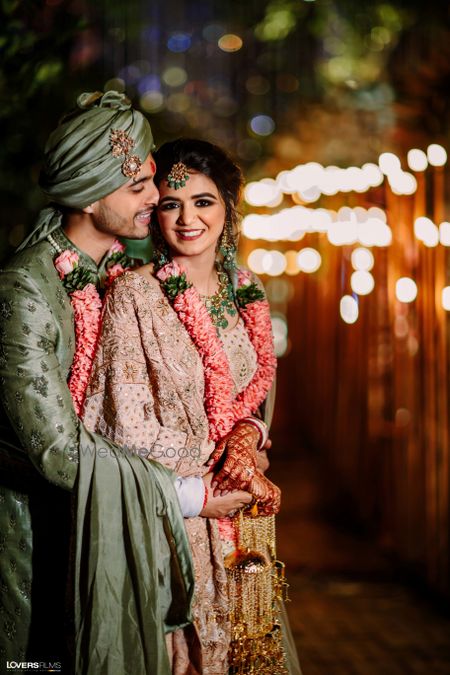 Photo of A lovely couple portrait of a bride and groom in pastel outfits.