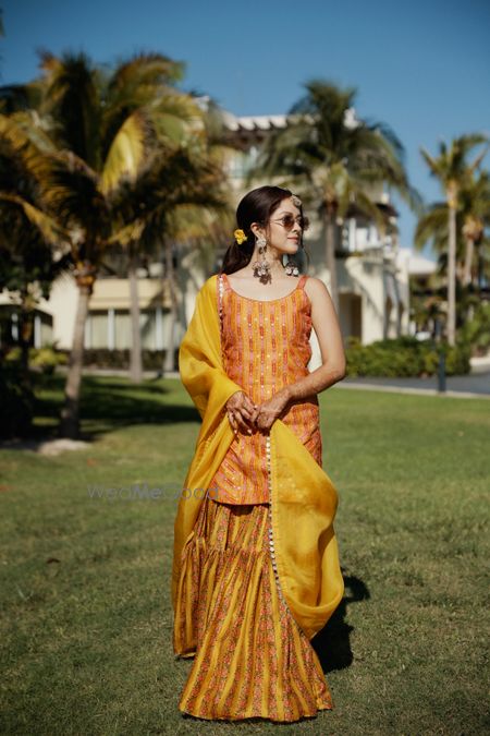 Photo of bride wearing a mustard sharara for her haldi