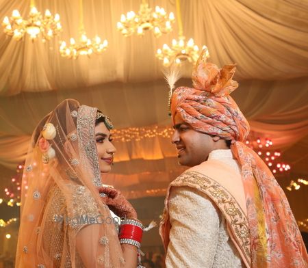 Photo of Orange floral safa for groom