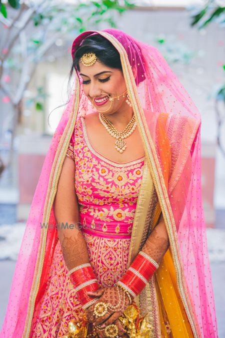 Photo of bright pink bridal lehenga  by shyam narayan prasad