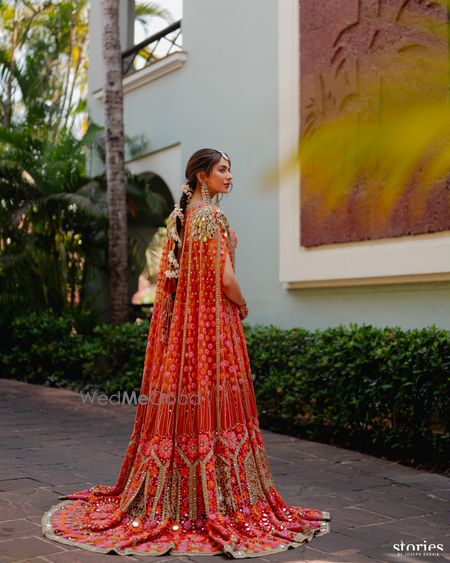 Photo of Stunning ornage and pink phulkari cape outfit with a gajra braid for the mehendi