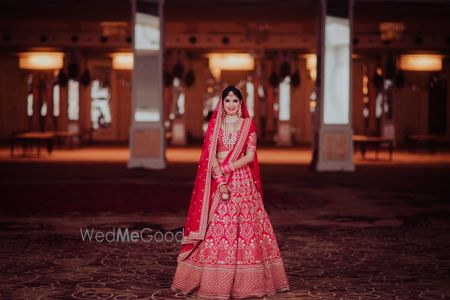 Photo of A bride in a red lehenga and double dupatta for her wedding