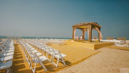 Photo of Beach wedding gold and white mandap with rose gold structure