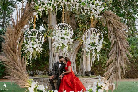 Photo of Cute couple portrait under a floral decor setup