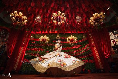 Photo of Birde twirling in floral sabyasachi lehenga