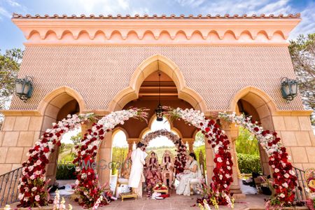 Photo of unique circular floral mandap idea with maroon and white flowers