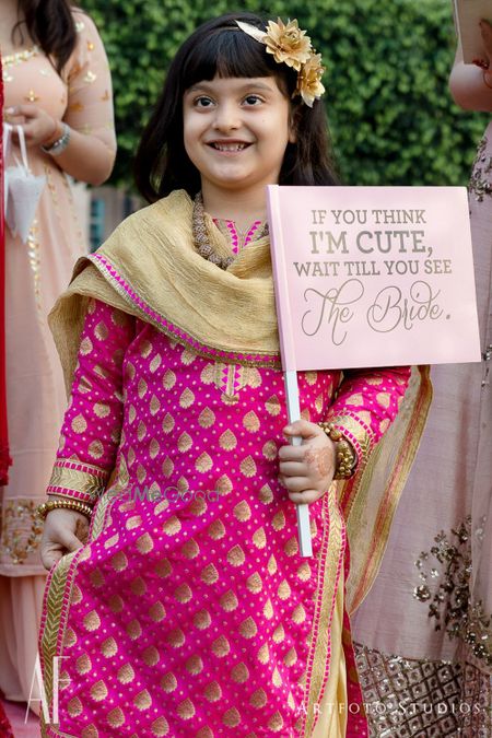 Photo of Bridal entry idea with niece holding cute board