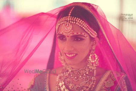 Photo of bride with fuschia pink veil