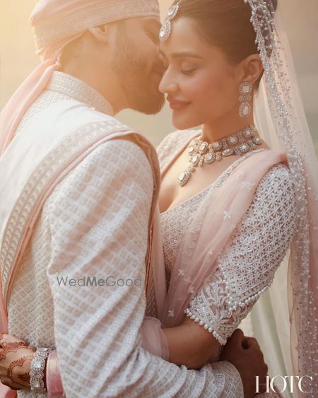 Photo of A intimate couple portrait on the wedding day with the couple in all-white ensembles