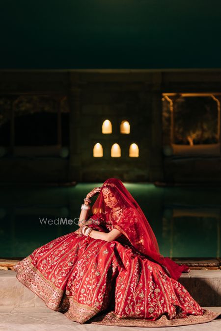 Photo of bride on her wedding day in red lehenga