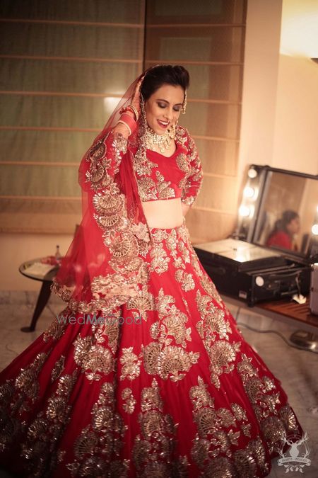 Photo of Red and gold bridal lehenga by Manish Malhotra