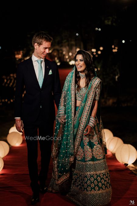 Photo of Couple on the reception with bride in a green lehenga