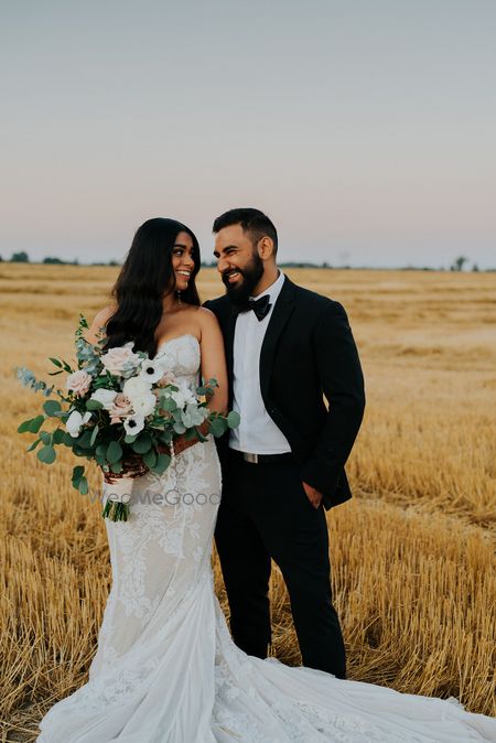 Photo of A christian couple pose after their wedding ceremony