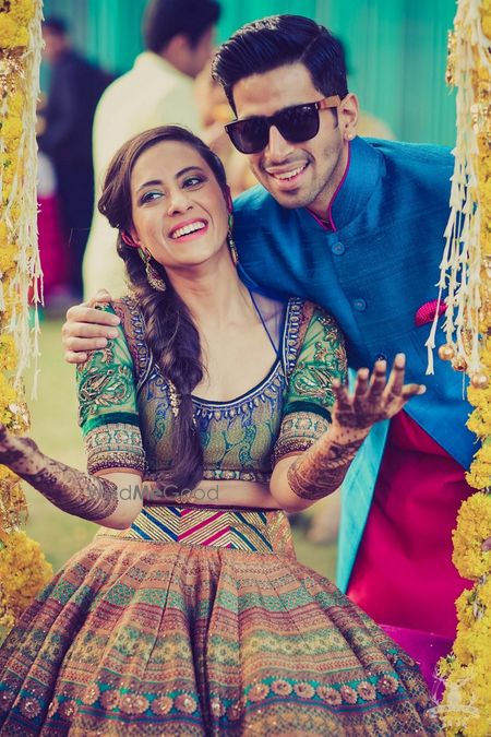 Photo of Bride and groom on mehendi swing