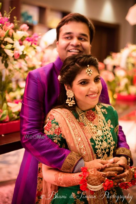 Photo of Bride and groom contrast outfit on sangeet