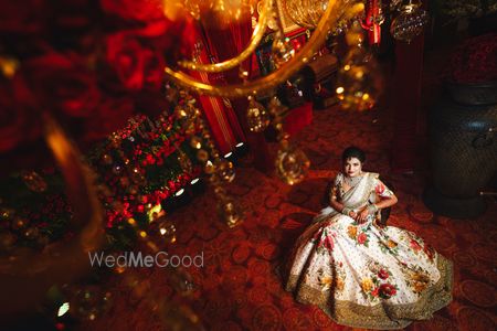 Photo of Top shot of bride in floral sabya lehenga