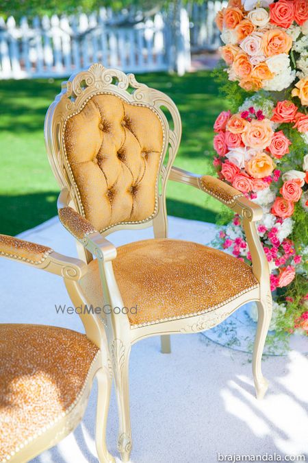 Photo of Gold cushion chair at mandap