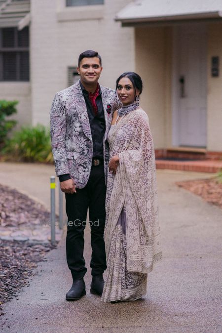 Photo of coordinated bride and groom in lavender outfits for welcome dinner